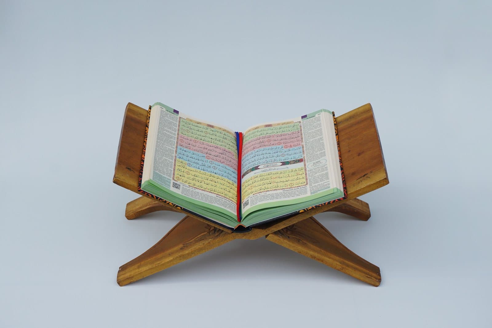 Quran on a wooden rehal at a quiet study desk