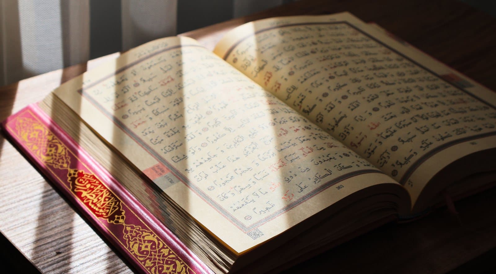 Open Quran showing Arabic verses in close-up